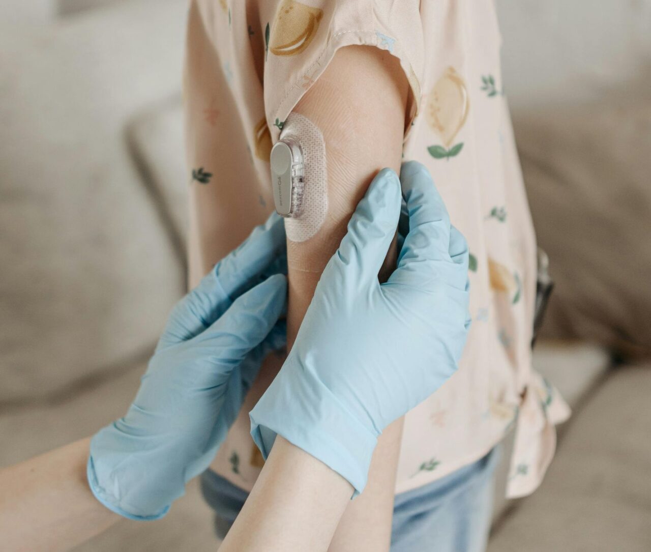 someone in medical gloves putting a bandage on a child's arm
